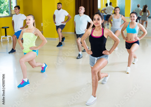 Young people exercising in dance hall