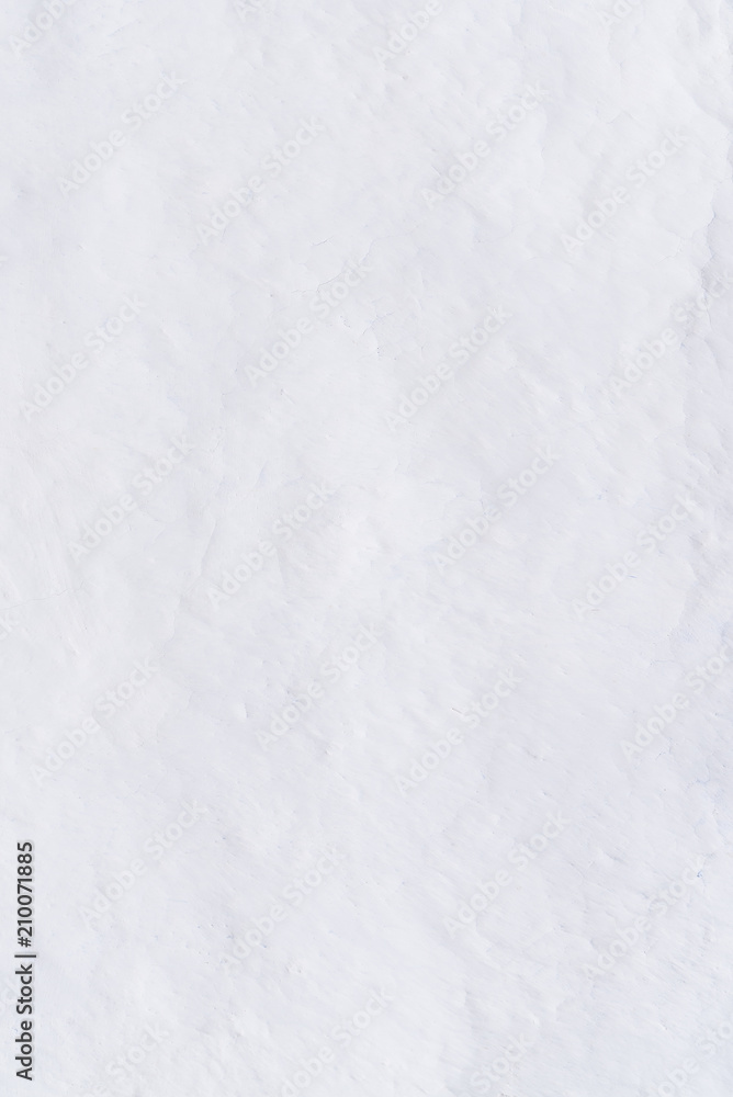 Adobe whitewashed wall in natural white color, traces of brush, texture, background with copy space for text or objects