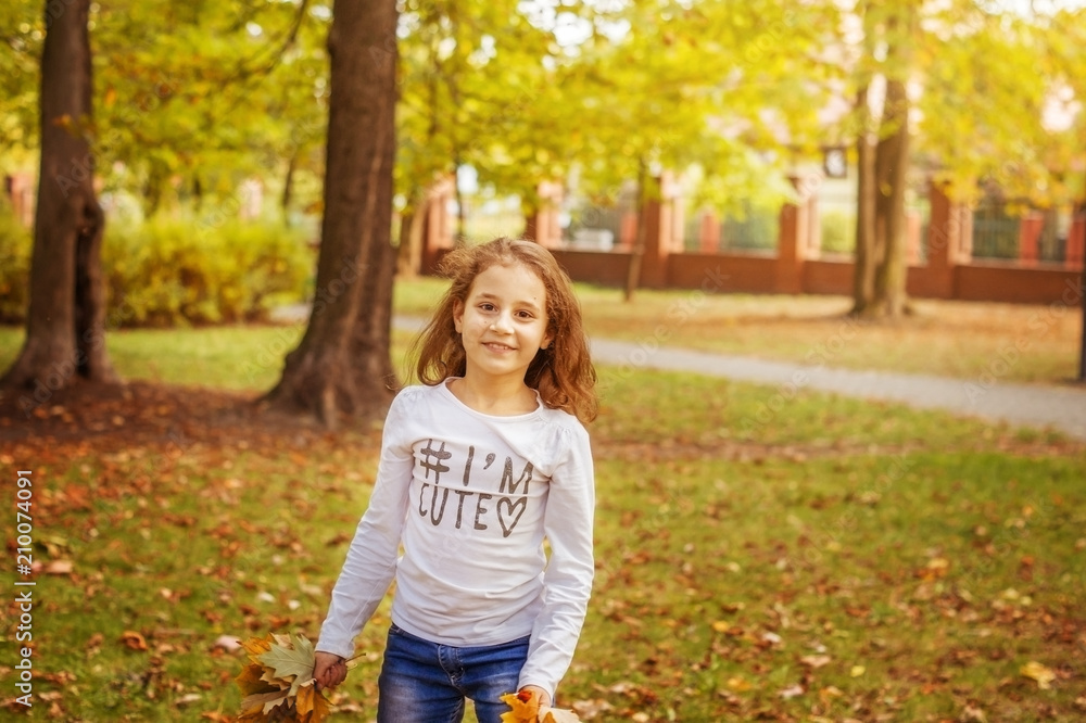 Cheerful girl child running around with yellow leaves in the autumn Park. Cheerful girl child running around with yellow leaves in the autumn Park.