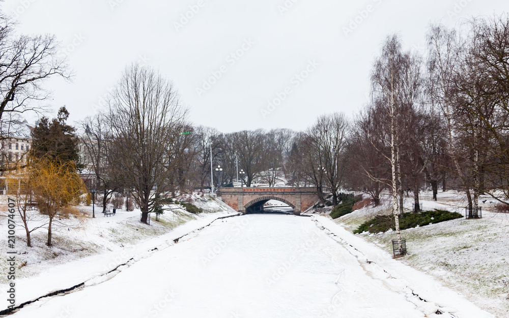 Riga Canal.  A winter view along a frozen Riga canal.  The canal flows through Bastion Hill park in Riga, Latvia.