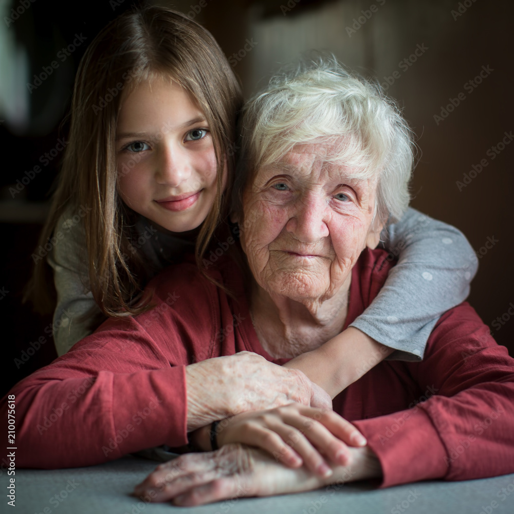 Portrait of an elderly woman with her little granddaughter. Old and young.  Stock Photo | Adobe Stock