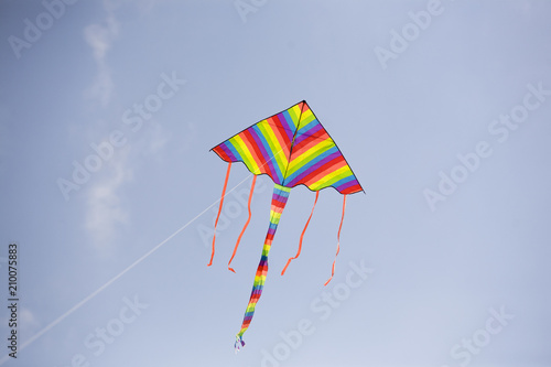 A beautiful colorful kite on a sunny sky