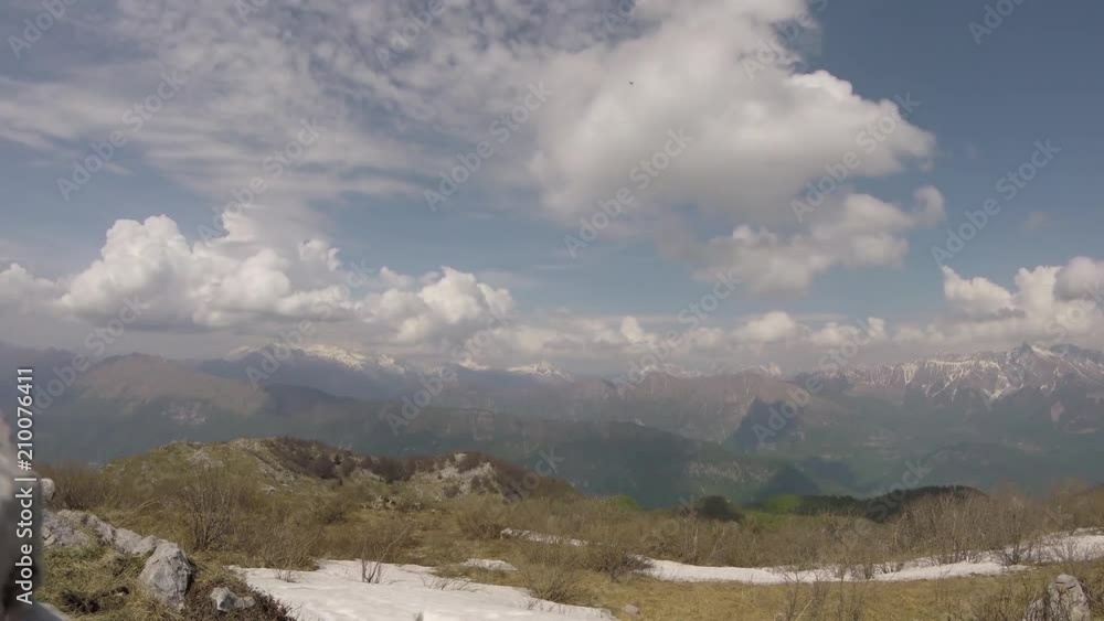 Time lapse (static) with unrecognizable people hiking and clouds moving upon mountain environment Time lapse (static) with unrecognizable people hiking and clouds moving upon mountain environment