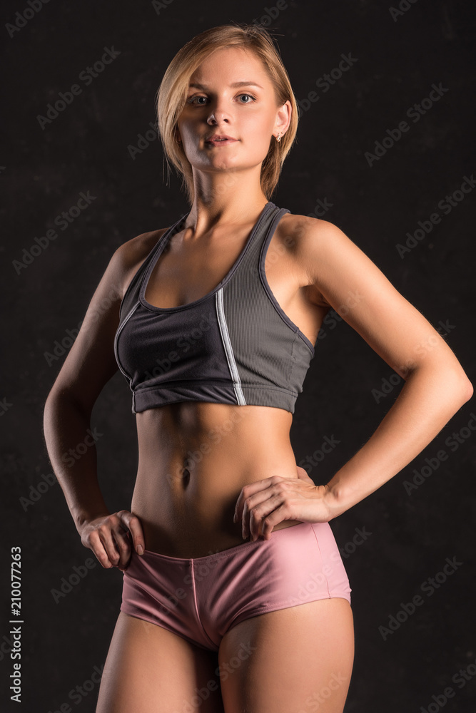 Obraz premium Girl beach volleyball player on a dark background