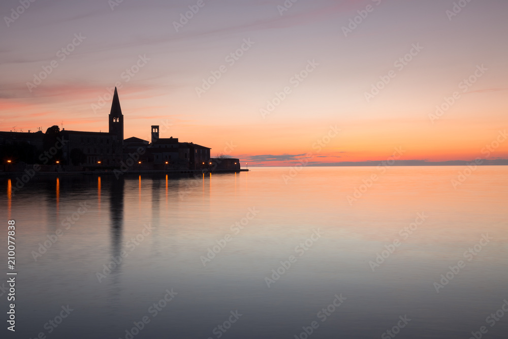 View on a historic center of Porec town and sea at evening after a sunset, Croatia, Europe.