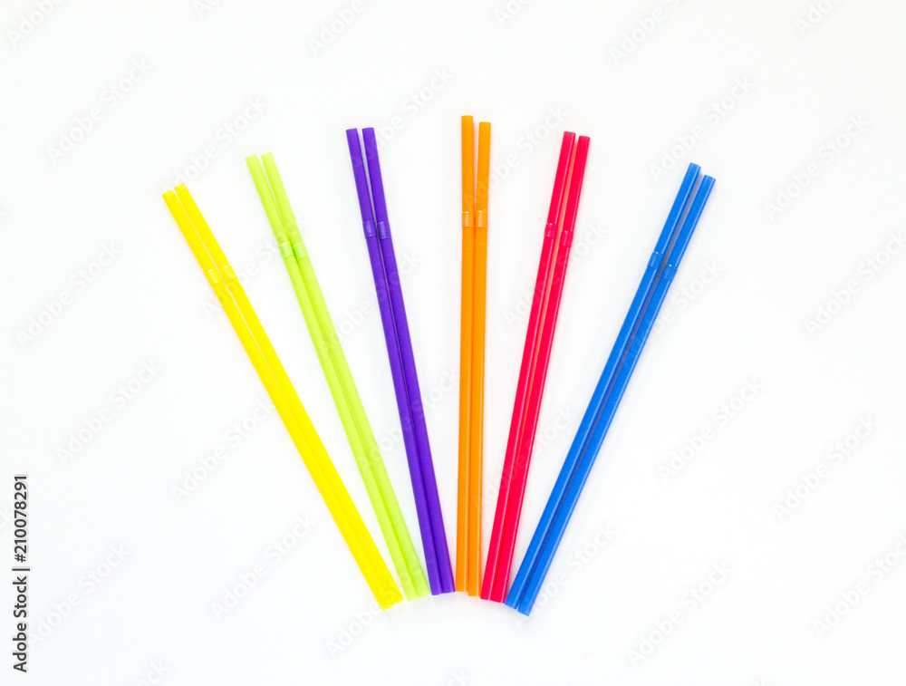 colorful plastic drinking straws fanned out in matching pairs isolated on white
