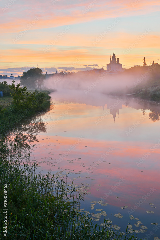 Suzdal town landscape. It is a gem of the Golden Ring of Russia route, famous tourist destination. View to the Alexandrovsky convent from the Kamenka river bank.