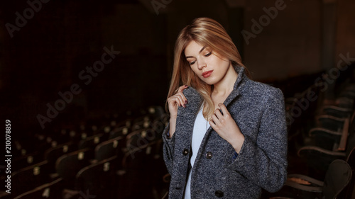 Outdoor lifestyle portrait of beautiful blonde young woman. Posing on urban background. Fashion Photo
