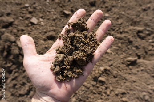 Hand full of brown soil