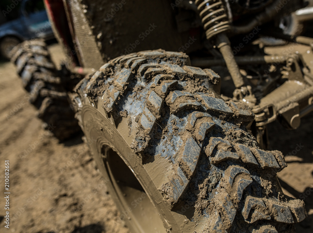 Wheels of off road car stuck full of mud
