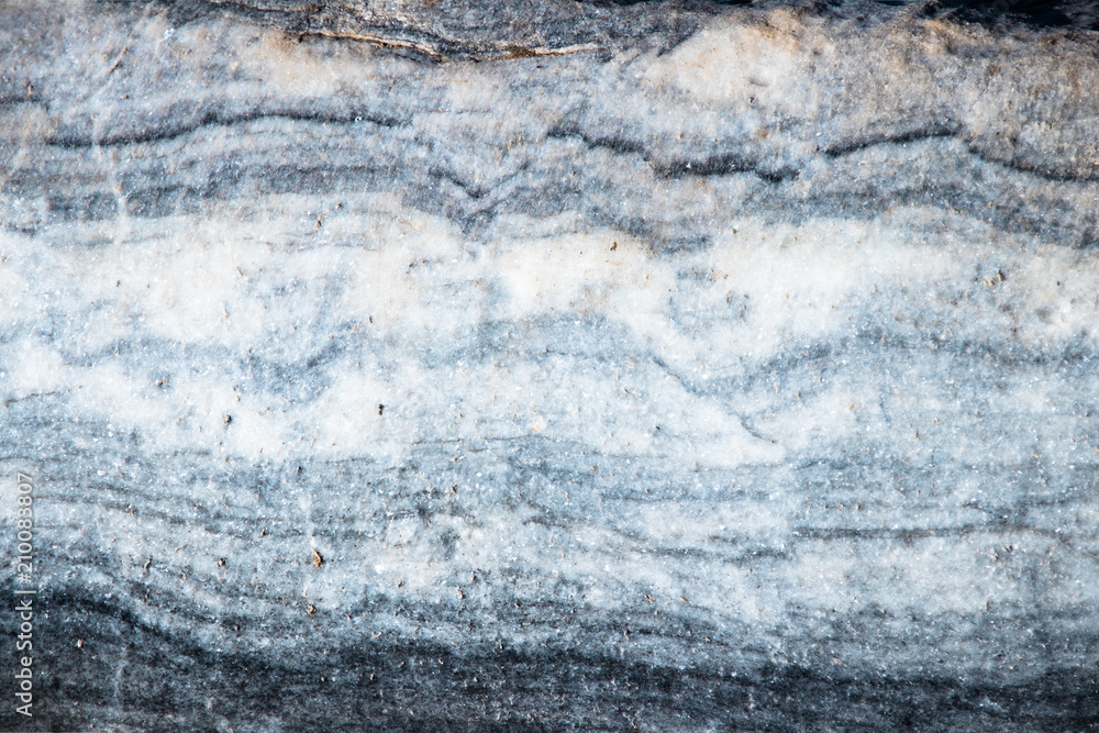 Naklejka premium The background is a natural plate Karar marble. The background is a natural plate made of white with blue, yellow and purple veins of Karar marble