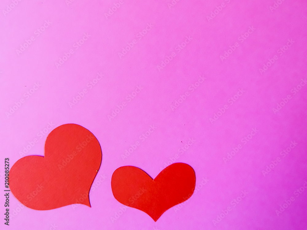 Red paper hearts on a pink paper background Red paper hearts on a pink paper background