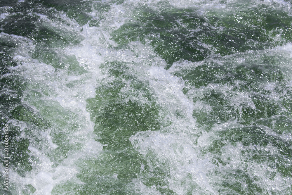 Background of churning bubbling green water behind a boat on the lake Background of churning bubbling green water behind a boat on the lake