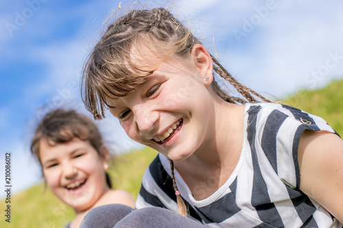 outdoor portrait of young happy child girl having fun on natural background © Alena Yakusheva
