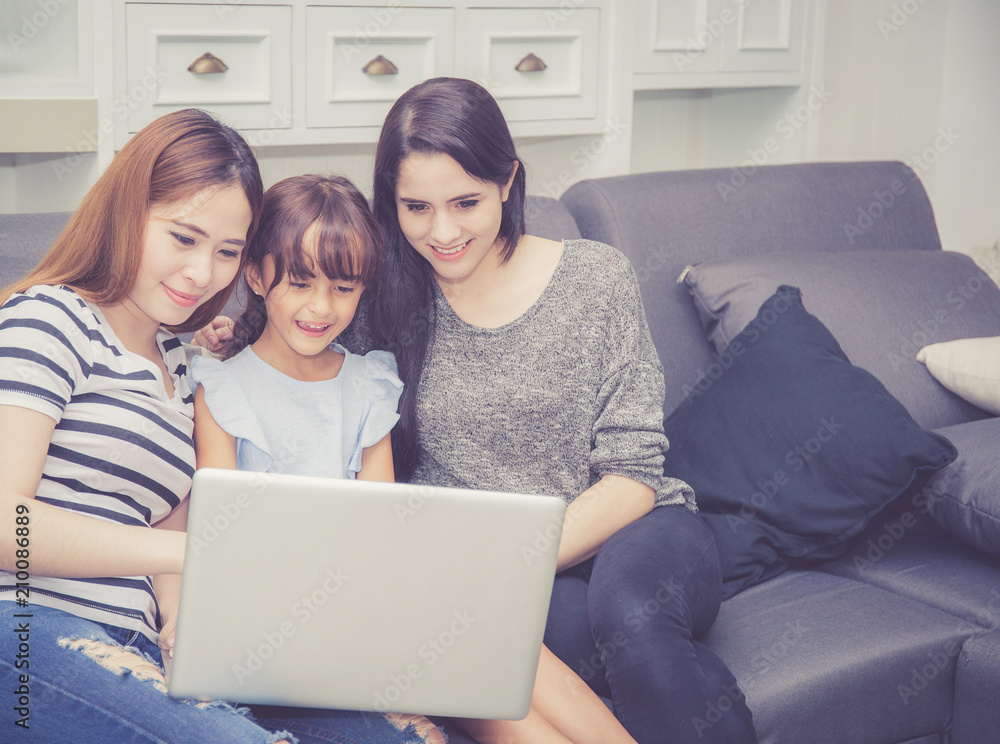 Mother, Aunt and kid having time together lerning with using laptop computer at home with relax and happy on couch, education and lifestyle concept. Mother, Aunt and kid having time together lerning with using laptop computer at home with relax and happy on couch, education and lifestyle concept.
