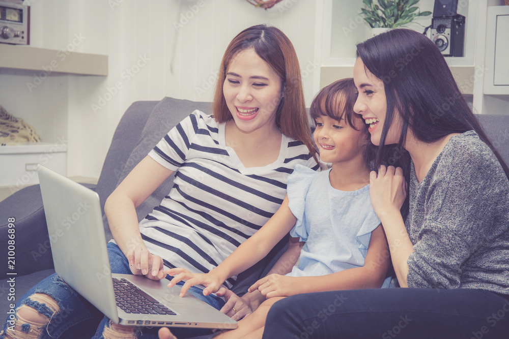 Mother, Aunt and kid having time together lerning with using laptop computer at home with relax and happy on couch, education and lifestyle concept. Mother, Aunt and kid having time together lerning with using laptop computer at home with relax and happy on couch, education and lifestyle concept.