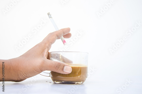 Woman's hand Holding a cup of coffee and holding a cigarette.