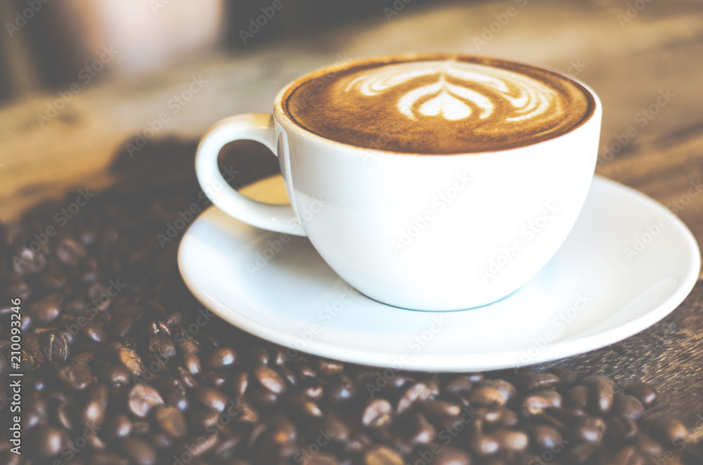 Coffee cup on wood table with coffee bean Coffee cup on wood table with coffee bean