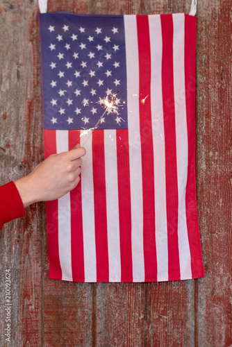 Patriotic background with red barn door, flag and sparklers