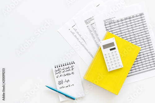 Math homework. Math textbook or tutorial near sheet with numbers, countes, calculator, notebook with formula on white background top view copy space