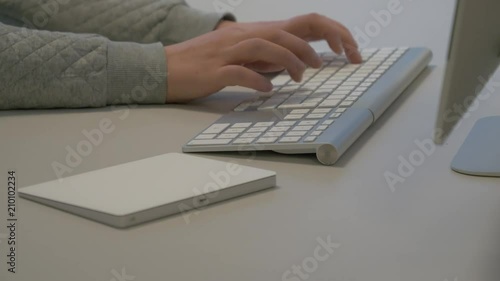 Typing on a keyboard. With a wireless keyboard. photo