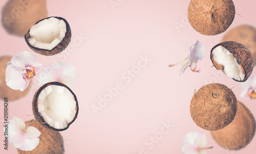 Pink tropical summer background with falling coconuts