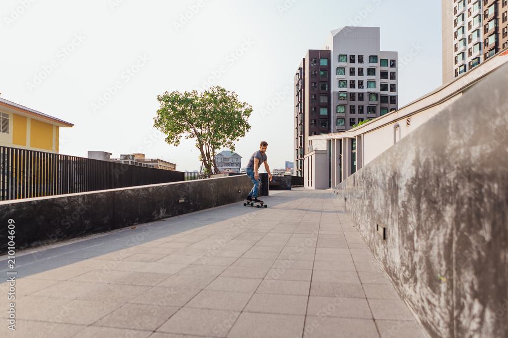 Young man riding skateboard on the street.