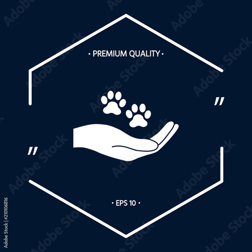 Hand holding paw symbol. Animal protection