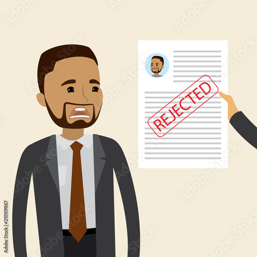 A frustrated businessman or office worker with claim form with rejected stamp