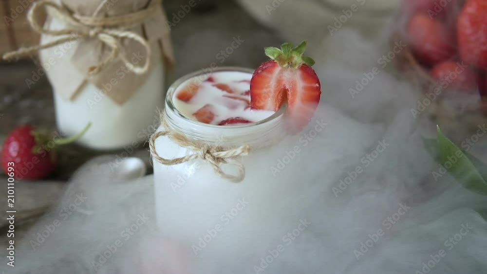 Organic yogurt with strawberries in a glass jar. Organic yogurt with strawberries in a glass jar.