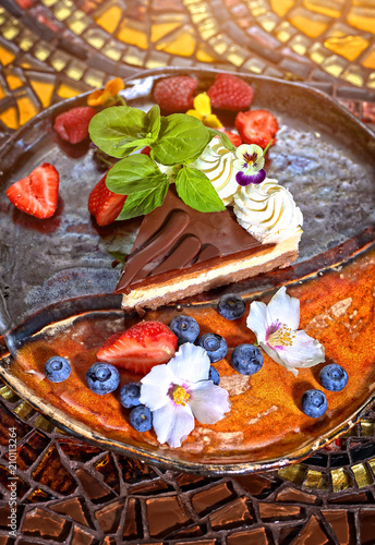 cake with creme and chocolate fruits in restaurant