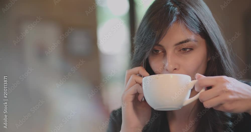 young attractive girl talking on phone and drinking coffee 4k young attractive girl talking on phone and drinking coffee 4k