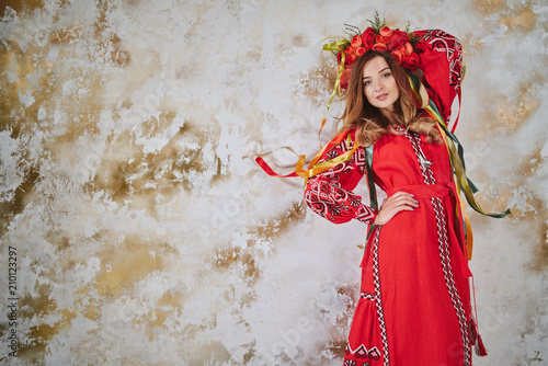 Beautiful woman in national Ukrainian red blouse on white background