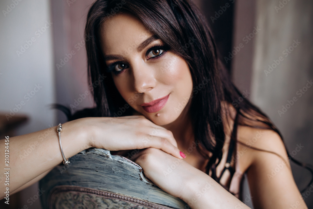 Fototapeta premium The stylish lady sitting on the sofa