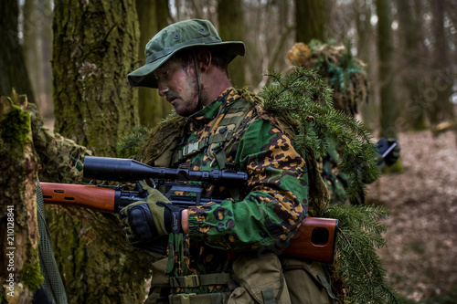 Airsoft player during patrol in forest