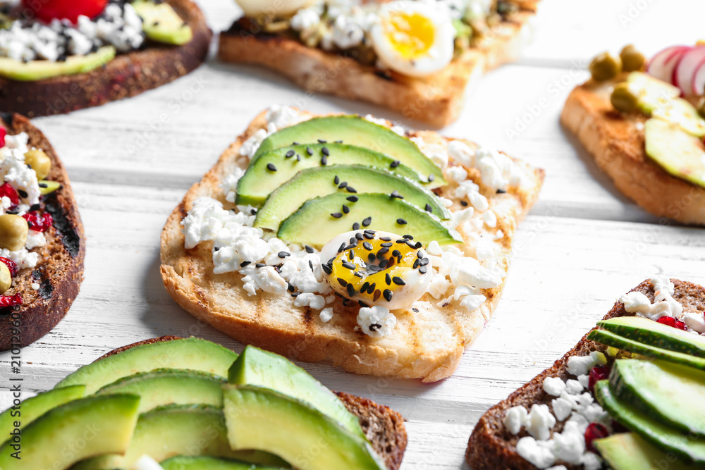 Tasty toasts with avocado on wooden background Tasty toasts with avocado on wooden background