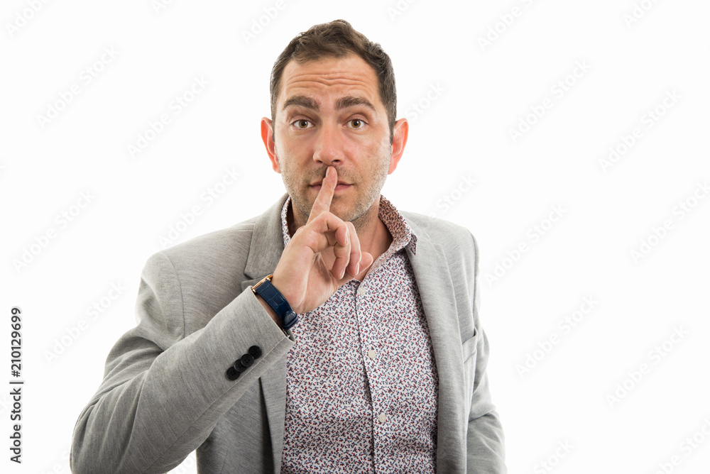 Portrait of business man making silence gesture Portrait of business man making silence gesture