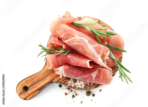 Wooden board with prosciutto on white background
