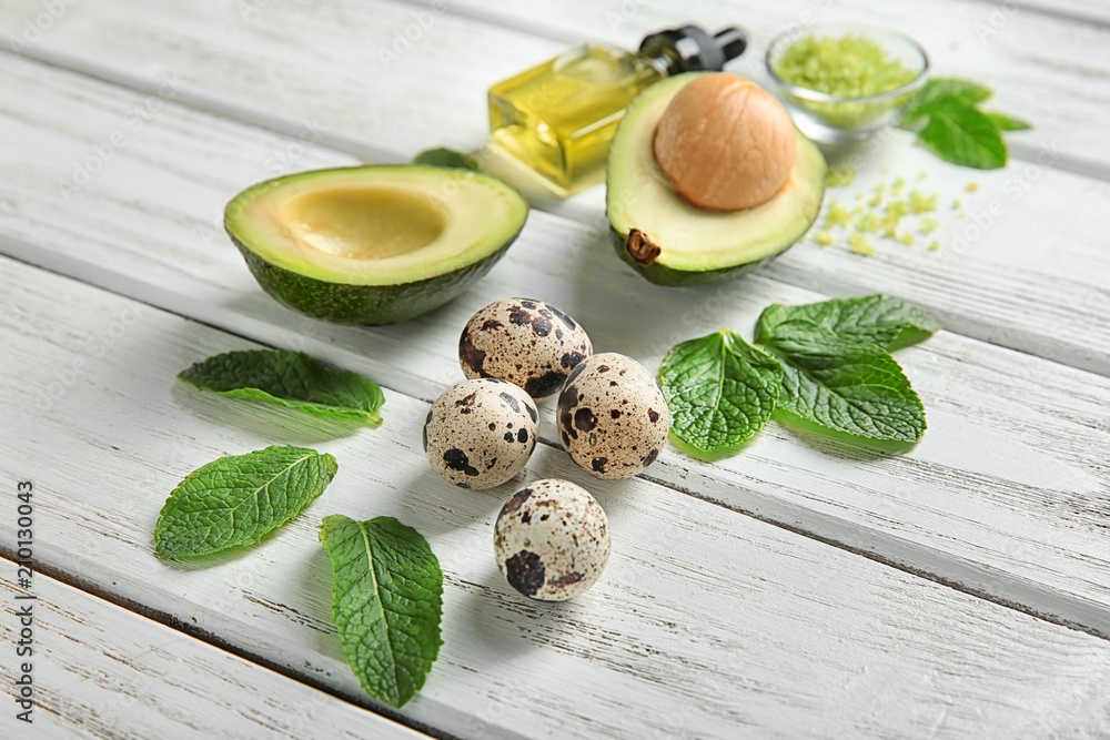 Avocado with ingredients for natural homemade cosmetics on wooden background Avocado with ingredients for natural homemade cosmetics on wooden background