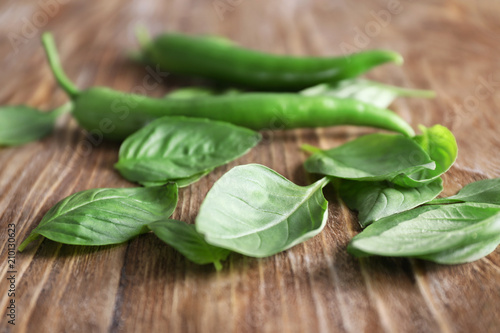 Fresh basil leaves on wooden background, closeup