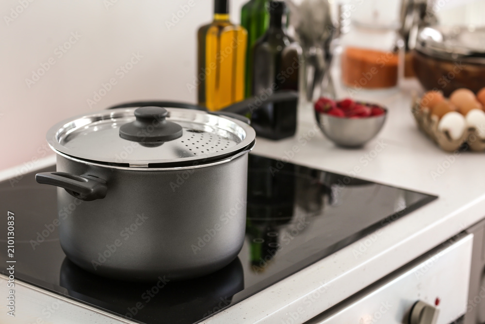 Electric stove with stewpan in kitchen Electric stove with stewpan in kitchen