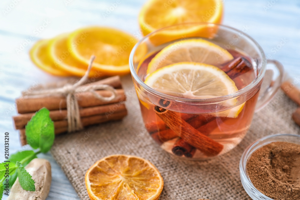 Cup of hot aromatic beverage with ingredients on table Cup of hot aromatic beverage with ingredients on table