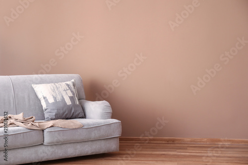 Fototapeta Naklejka Na Ścianę i Meble -  Comfortable sofa near color wall in living room