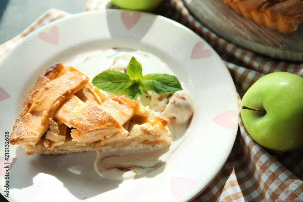 Plate with piece of delicious apple pie on table Plate with piece of delicious apple pie on table