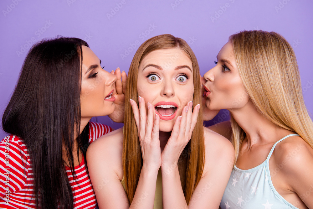Portrait of astonished girl with wide open eyes mouth listening gossips on two ears from friends isolated on vivid violet background Portrait of astonished girl with wide open eyes mouth listening gossips on two ears from friends isolated on vivid violet background