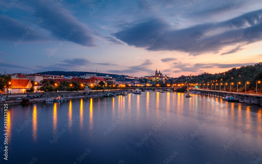 Prague, Czech Republic bridges panorama with historic Prague Castle and Vltava river after the sunset