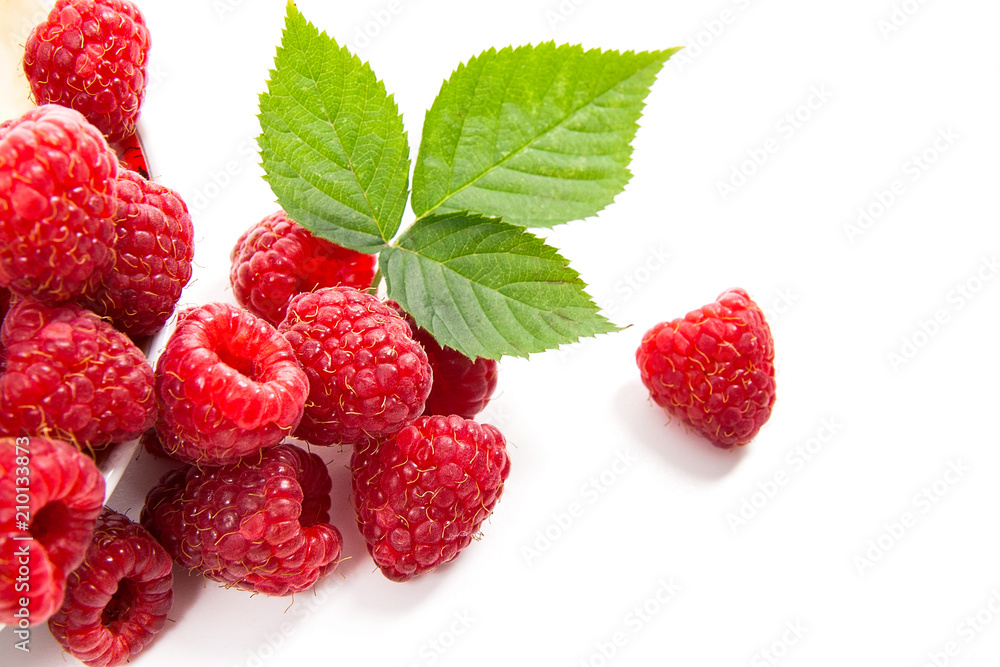 Small plate with ripe raspberries and green leaf isolated on white background. Small plate with ripe raspberries and green leaf isolated on white background.