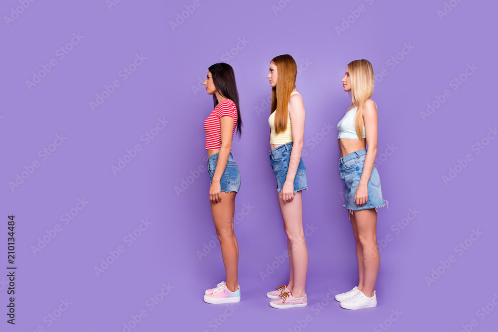 Fototapeta premium Weight loss healthy lifestyle concept. Side view profile portrait of calm slender girls in casual outfits isolated on vivid violet background