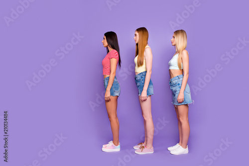 Weight loss healthy lifestyle concept. Side view profile portrait of calm slender girls in casual outfits isolated on vivid violet background