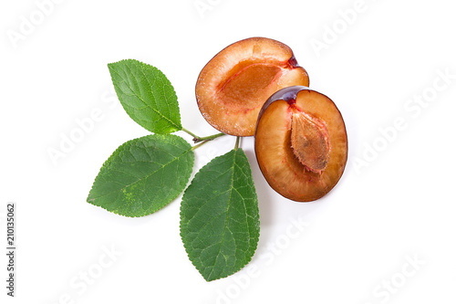 Half of ripe plum with leaf isolated on a white background..